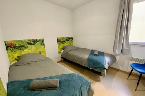 a bedroom with two beds and a chair and a window at Les Naïades H43 - 2 bedrooms for 6 people ! in Avène