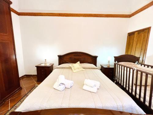 a bedroom with a bed with towels on it at Nonna Sasà in Torretta