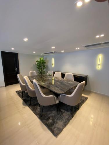 a conference room with a table and chairs at Luxurious Family 5BR Pool View Near Airport! in Cairo