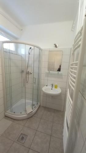 a bathroom with a shower and a sink at Elena Villa in Hévíz