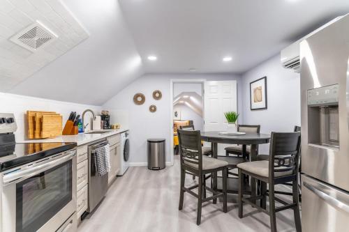 a kitchen with a table and chairs in it at Burien's Top Unit with Spa-Inspired Bathroom in Burien