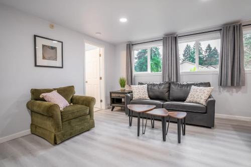 a living room with a couch and a chair and a table at Burien's Top Unit with Spa-Inspired Bathroom in Burien