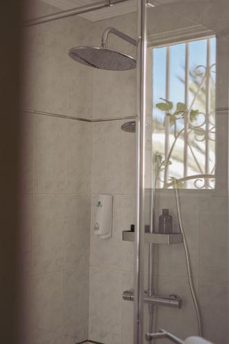 a shower with a glass door in a bathroom at Acapulco Ocean View in San Agustin