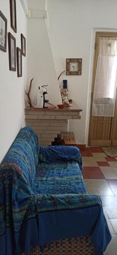 a bedroom with a bed in a room with a fireplace at Borgo Ingurtosu in Ingurtosu