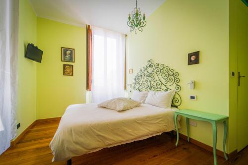 a bedroom with a bed with a table and a window at La casa dei Paggi in Sestri Levante