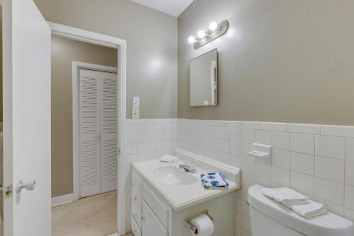 a white bathroom with a sink and a mirror at Garden District Home Near Downtown Montgomery in Montgomery