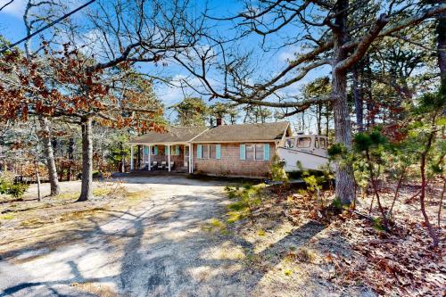 a house in the woods with a driveway at Eastham Glen in Eastham