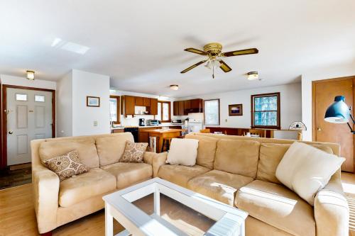 a living room with a couch and a ceiling fan at Eastham Glen in Eastham