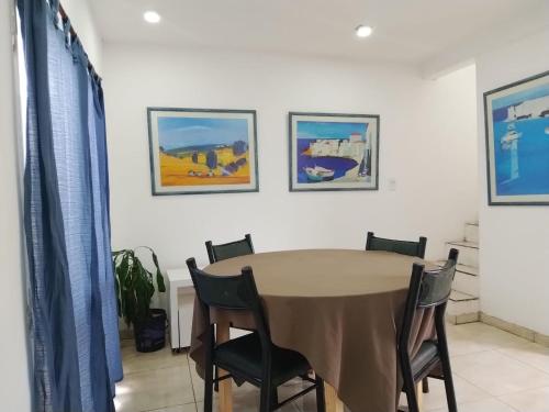 a dining room with a table and chairs at Duplex CATALINA 2 in La Plata