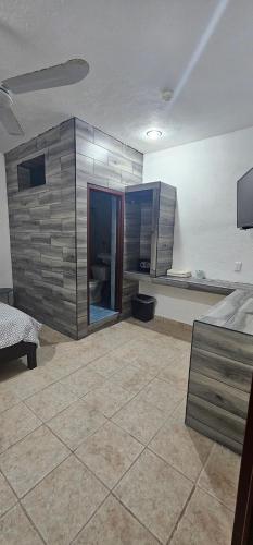 a large room with a bed and a kitchen at Hotel posada MARCAS in Canc&uacute;n