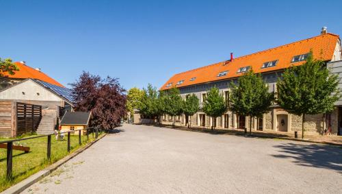 a street in a town with a building with an orange roof at Chateau Nightingales in Hostouň