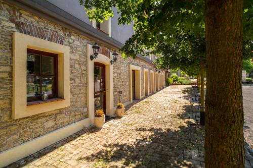 a cobblestone street in front of a building at Chateau Nightingales in Hostouň