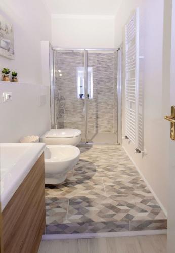 a bathroom with a shower and a toilet and a sink at Chez Amèlie in La Spezia