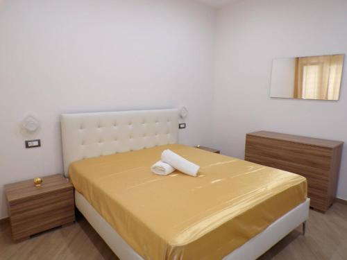 a bedroom with a yellow bed with two night stands at Two-room Marina Apartment Near the Sea Climate - Wi-fi in Avola