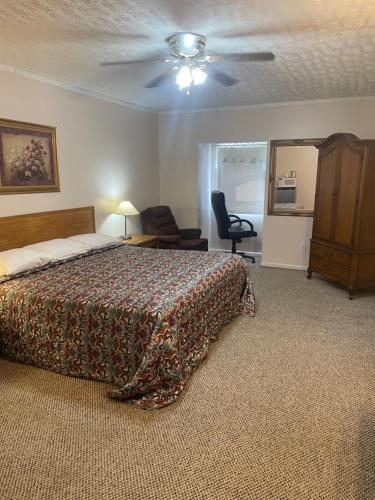 a bedroom with a bed and a ceiling fan at The Valley Inn in Maggie Valley