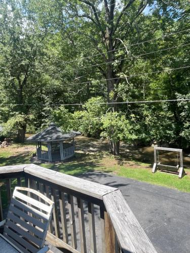 a wooden deck with a bench and a gazebo at The Valley Inn in Maggie Valley