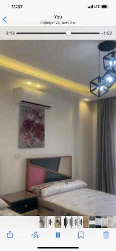 una imagen de una habitación con una cama y una foto en Fully furniture apartment in Madinty Egypt, en Madinaty