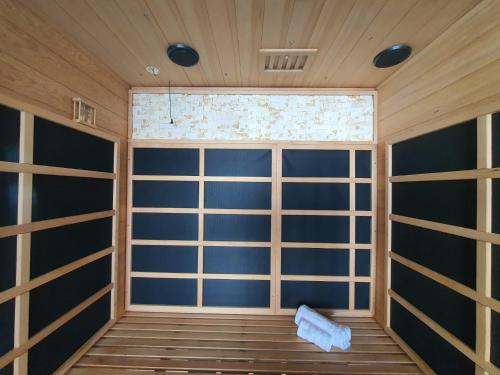 a sauna with blue walls and a window at Stunning 1 King bed cabin in Grays in Grays Thurrock