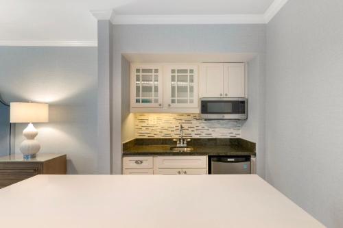 a kitchen with white cabinets and a sink at Omni Hilton Head Oceanfront Resort in Hilton Head Island
