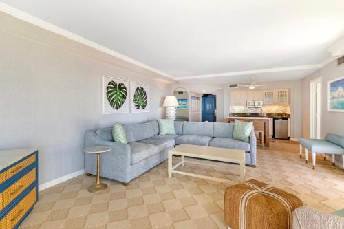 a living room with a blue couch and a table at Omni Hilton Head Oceanfront Resort in Hilton Head Island