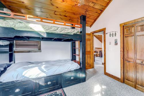 a bedroom with a bunk bed in a house at 1 Mi to Beech Mtn Skiing: Family Cabin w/ Fire Pit in Beech Mountain