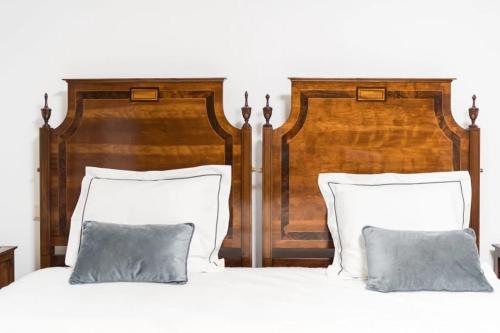 two large wooden beds with pillows in a bedroom at Casa da Torre in Vieira do Minho