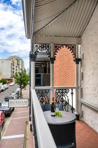 a balcony with a table on a building at Durham Serviced Apartments in Adelaide