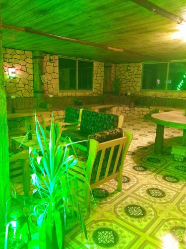 a living room with a bench and a table at Dana local life Eco Lodge in Dana