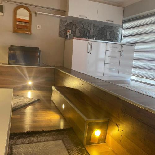 a kitchen with a wooden counter top with a refrigerator at Smirnapalasapartotel in Konak