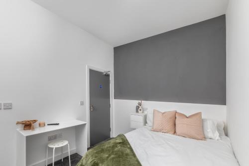 a white bedroom with a bed and a desk at Kilwick Lodge, Hartlepool City Centre, Room Stay in Hartlepool