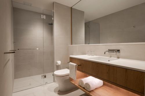 a bathroom with a sink and a toilet and a shower at Courtyard by Marriott Perth Murdoch in Fremantle