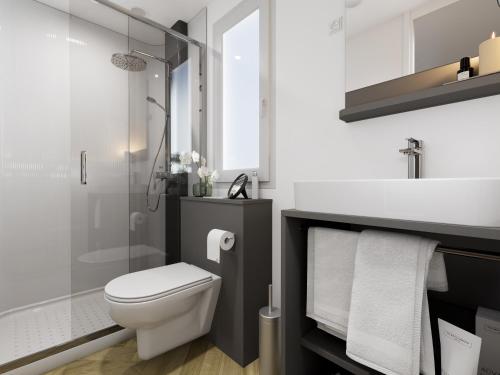 a bathroom with a toilet and a sink and a shower at Holiday Mobile Homes Park Riviera in Novigrad Istria