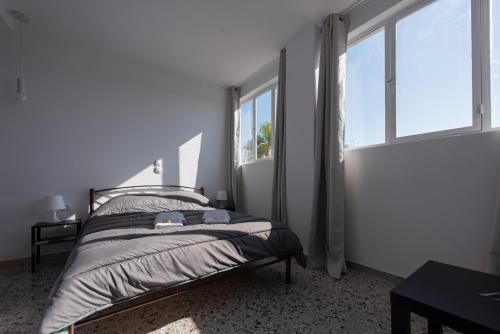 a bedroom with a bed and a large window at Liberal Gazi in Athens