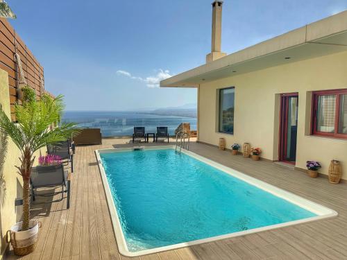 a swimming pool on the deck of a house at Villa Balcony, Cozy Villa with Amazing View in Rodhiá
