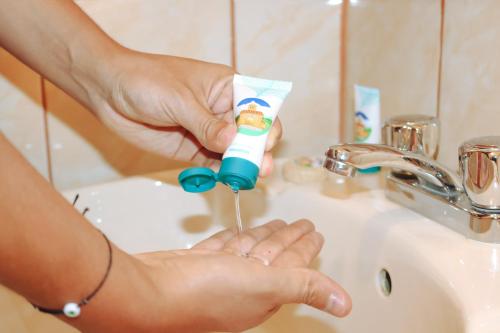 a person holding a toothbrush in front of a sink at Las Torrecitas in Carhuaz
