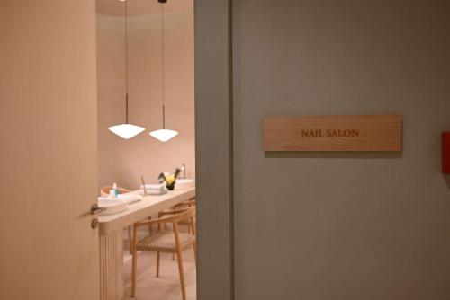 a dining room with a table and a door with a mirror at Mansard Riyadh, a Radisson Collection Hotel in Riyadh