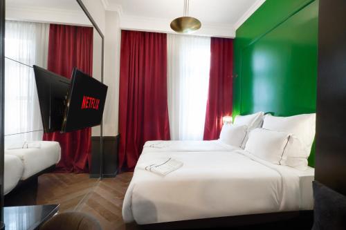 a hotel room with a bed with green and red curtains at Soho Athinas 60 in Athens