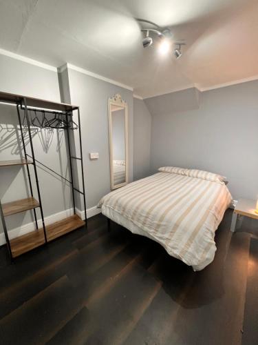a bedroom with a bed and a mirror at 82a Nelson Street in Kettering