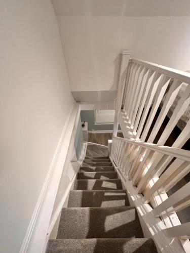 a staircase in a room with white walls at 82a Nelson Street in Kettering