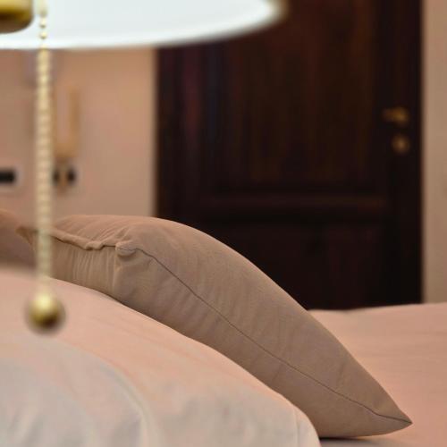 a pillow sitting on top of a bed at Residence Internazionale in Pietrasanta