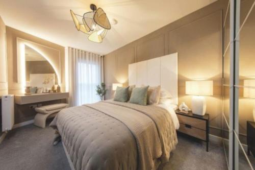 a bedroom with a large bed and a desk at Kings Cross Walking Distance Luxury Private Garden House in London