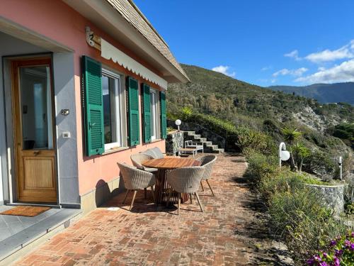 a patio with a table and chairs outside of a house at Villa Marta in Levanto