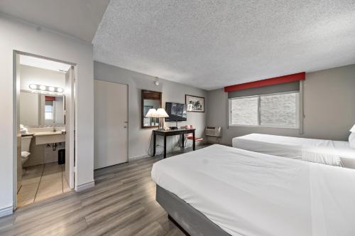 ロサンゼルスにあるRoyal Pagoda Motel Dodger Stadiumのベッド2台とバスルームが備わるホテルルームです。