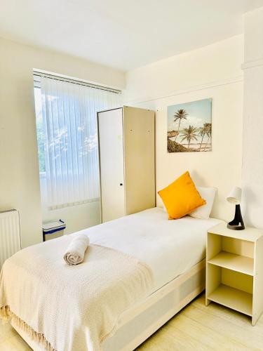 a white bedroom with a bed and a window at Whites Inn in London