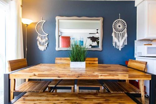 a dining room with a wooden table and a mirror at Cali Condo+BBQ+MemoryFoamBeds+12min to Beach in San Juan Capistrano