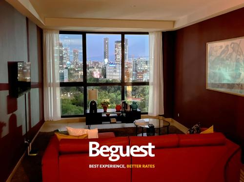 a living room with a red couch and a large window at Begrand Alto Polanco Pool Gym Jacuzzi & More in Mexico City