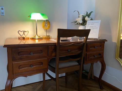 a wooden desk with a lamp and a chair at Magic Vienna right next to the Prater! in Vienna