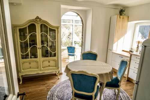 a kitchen with a table and chairs and a cabinet at Ferienwohnung Kaiserblick in Bad Ems
