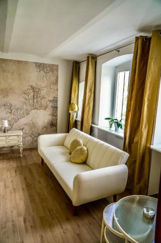 a living room with a white couch and a table at Ferienwohnung Kaiserblick in Bad Ems