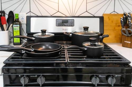 three pots on top of a stove in a kitchen at Stylish Casita min from the beach ! in San Juan Capistrano